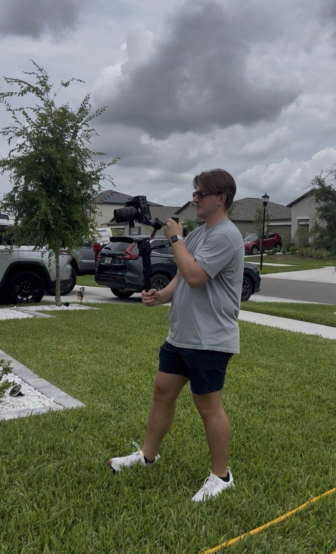 Garrett Porter filming with a gimbal outside a client's home